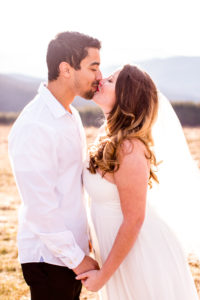 Couple kissing with Mountains in the Background